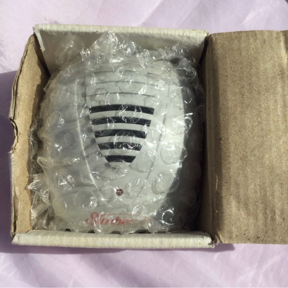 Pest Repellers Plug Wall Sunbeam with old cardboard box